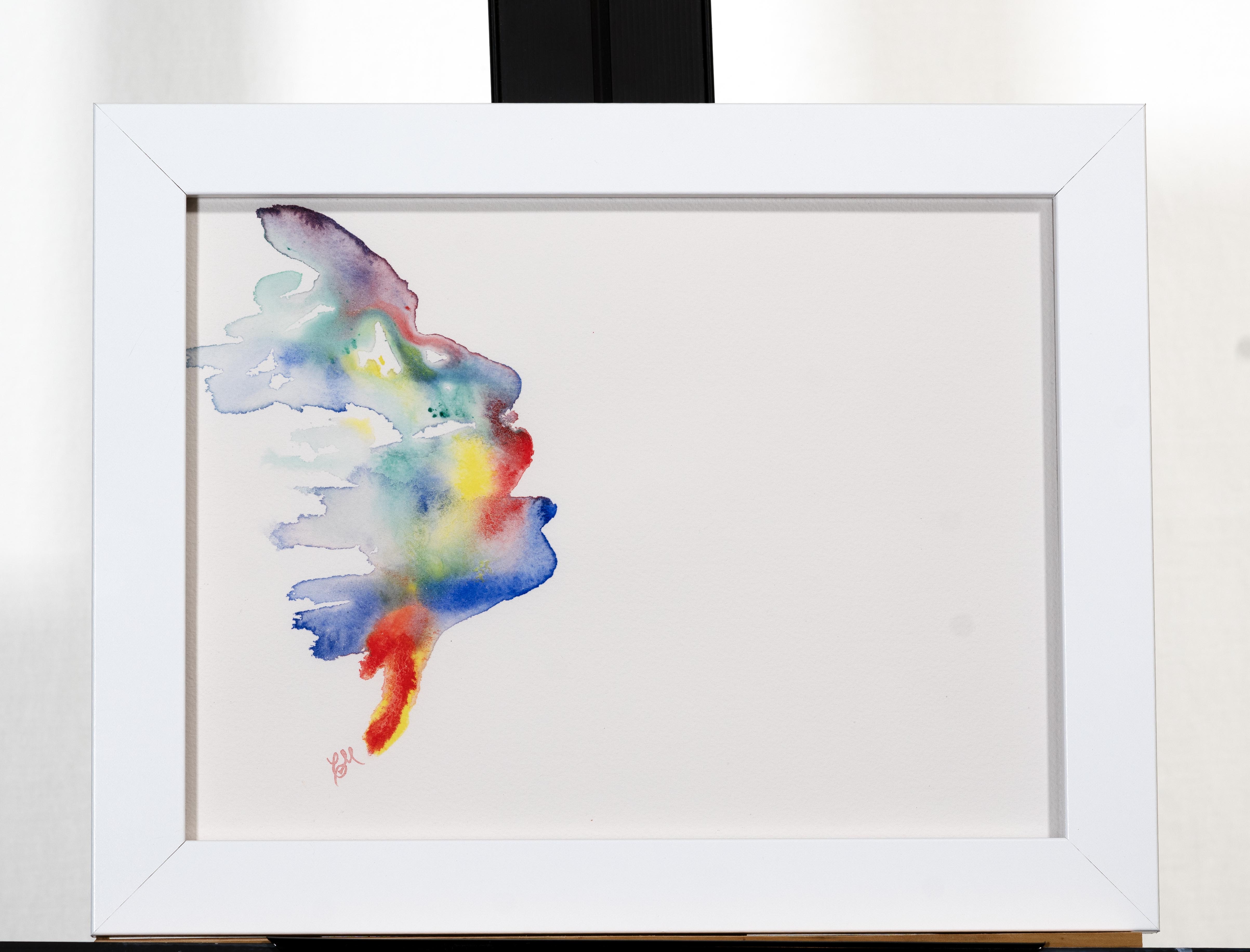 face emerging from watercolor on cotton paper